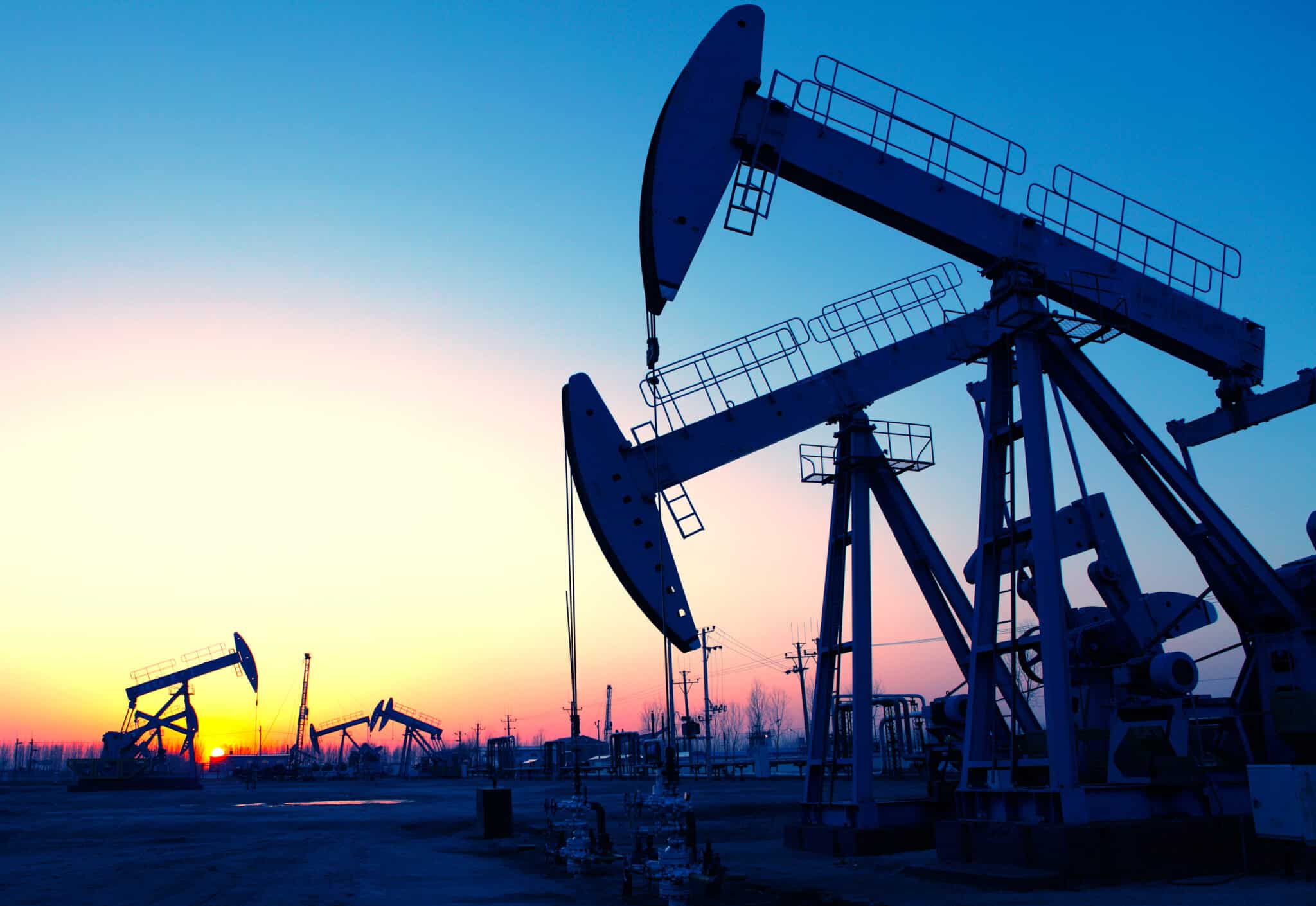 A photo of an oil pump at sunset